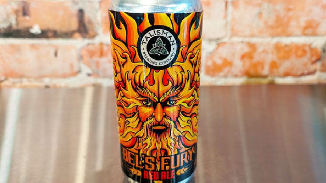 A can of Talisman Bel’s Fury Red Ale, featuring a fiery, flame-themed design with an illustration of a bearded man surrounded by flames on the label.